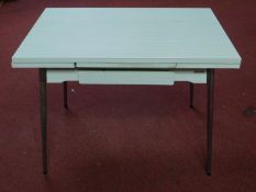 A vintage 1960's French Supermatic ?Le Tubmenager' extending dining table by Brevet, with formica