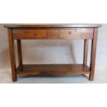 A contemporary teak console side table with two drawers on square supports joined by stretchered pot