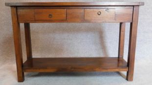 A contemporary teak console side table with two drawers on square supports joined by stretchered pot