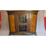 A 1930's German carved oak cabinet with burr walnut inlaid panel doors. H.185 W.233 D.40cm