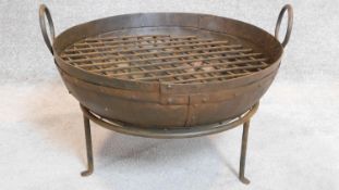 A metal Kadai fire pit on stand. 34x65cm