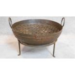 A metal Kadai fire pit on stand. 34x65cm