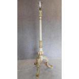 A painted French style standard lamp on tripod cabriole supports. H.160cm
