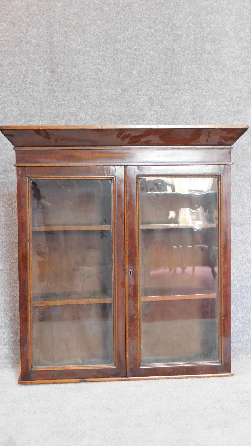 A 19th century mahogany glazed two door bookcase section. 72x69cm