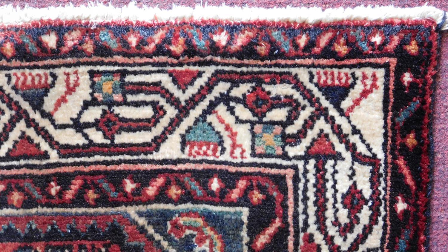 A Persian Malayer runner, repeating heratie motifs on a terracotta field within stylised multifloral - Image 4 of 4
