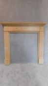 An Adam style pitch pine fire surround with carved and fluted pilasters. 140x150cm