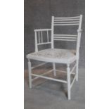 A late 19th century white painted stick back armchair in the William Morris style. H.80cm