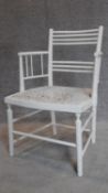 A late 19th century white painted stick back armchair in the William Morris style. H.80cm