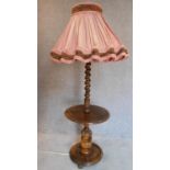 A vintage oak lamp standard with barleytwist column on circular carved base. H.73cm