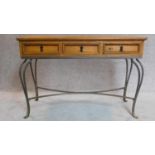 20th Century pitch pine console table with three drawers on cabriole wrought iron legs.