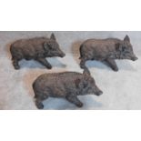 A family of three moulded figures of a baby boar. 30x50cm