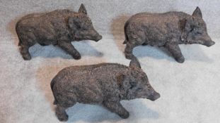 A family of three moulded figures of a baby boar. 30x50cm