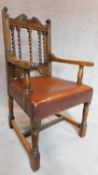 A late Victorian oak throne desk chair with tan leather upholstered seat. 111x60x56cm