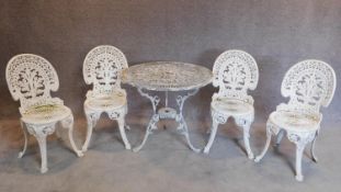 A Colebrookdale style garden table and the four matching chairs. H.84