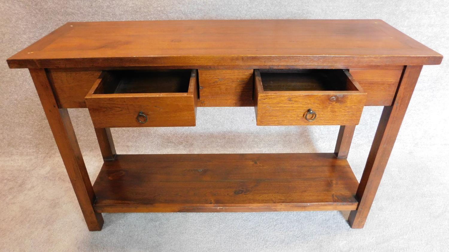 A contemporary teak console side table with two drawers on square supports joined by stretchered pot - Image 2 of 3
