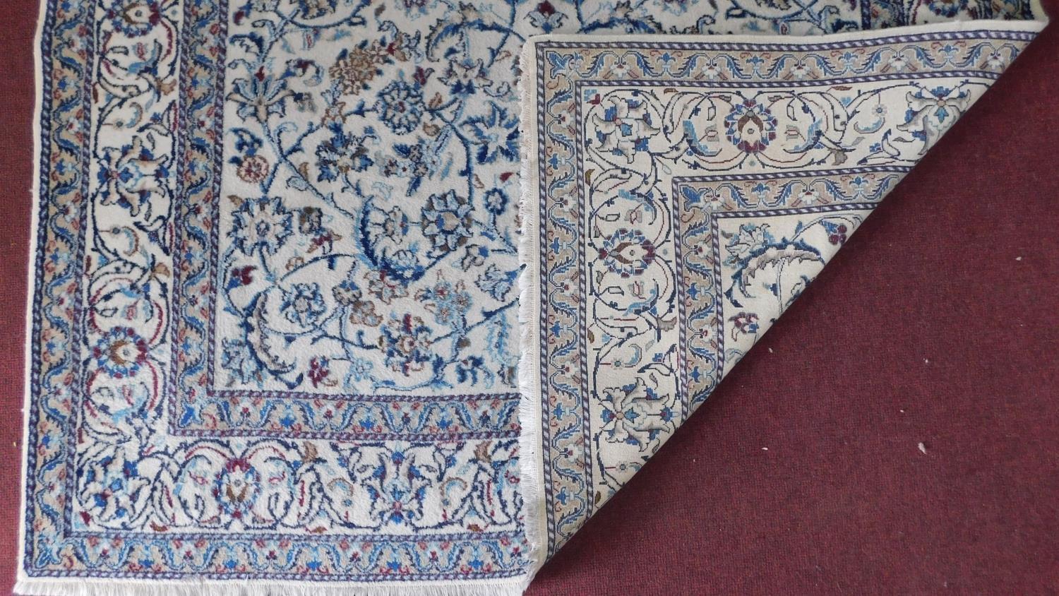 A part silk Nain Isfahan carpet with repeating spandrels and petal motifs on an ivory field - Image 2 of 4