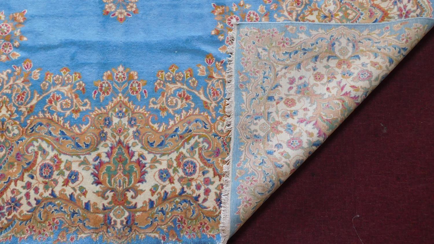 A Royal Kirman carpet with central double pendant medallion with repeating petal motifs on a sky - Image 3 of 4