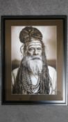 A framed and glazed monochrome photographic portrait of an elder tribesman. 90x67cm