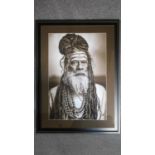 A framed and glazed monochrome photographic portrait of an elder tribesman. 90x67cm