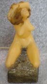 An unusual novelty telephone in the form of a naked woman. H.26cm