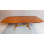 An extending "Burford" dining table with extra leaf and makers label; Gordon Russell Ltd,