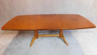 An extending "Burford" dining table with extra leaf and makers label; Gordon Russell Ltd,