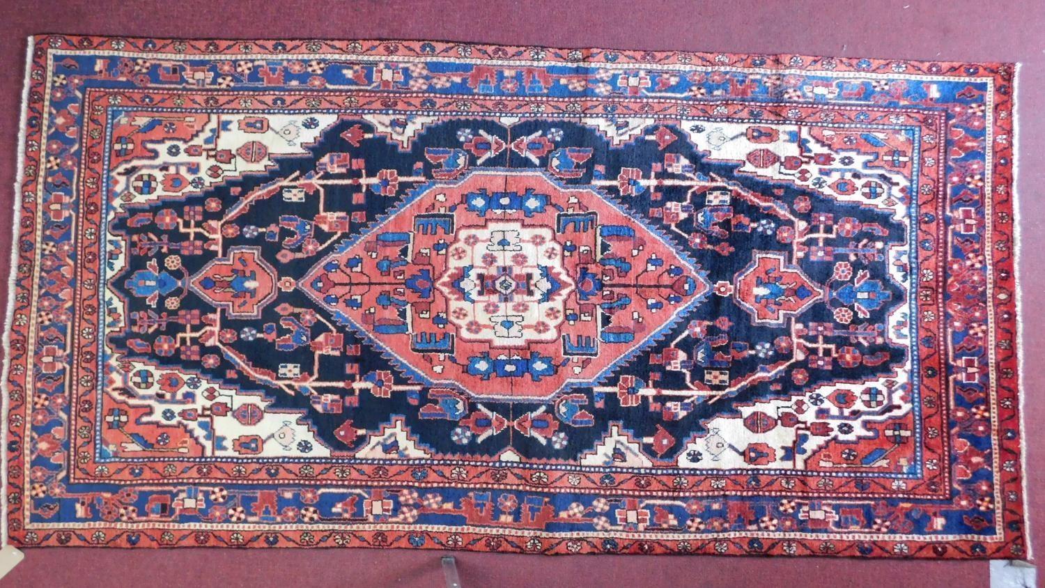 A north west Persian Nahawand carpet with central double pendant medallion with repeating petal