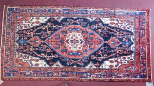 A north west Persian Nahawand carpet with central double pendant medallion with repeating petal