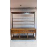 An 18th century country oak dresser, the upper plate rack section above base with frieze drawers