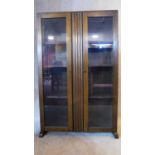 A mid 20th century oak bookcase with a pair of glazed doors. H.120 W.75 D.26cm