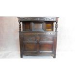 A mid 20th century carved oak Jacobean style court cupboard. H.137 W.129 D.42cm