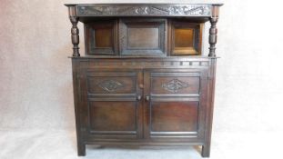 A mid 20th century carved oak Jacobean style court cupboard. H.137 W.129 D.42cm