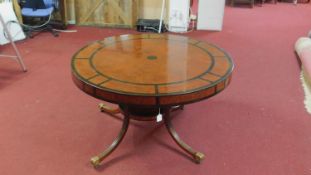 A mid 20th century Regency style walnut and part ebonized centre table, raised on 4 reeded splayed