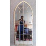 A pair of arched Gothic style window pane garden mirrors. 158x66cm