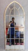 A pair of arched Gothic style window pane garden mirrors. 158x66cm