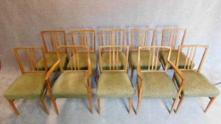 A set of ten teak Gordon Russell "Burford" dining chairs uphostered in sage cut moquette,