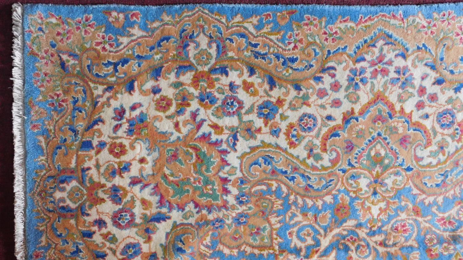 A Royal Kirman carpet with central double pendant medallion with repeating petal motifs on a sky - Image 4 of 4