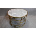 A circular gilt metal framed marble topped low table. 50x74cm