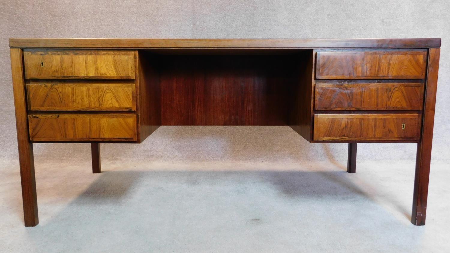 A 1960's rosewood desk, Model 77 by Omann Jun Mobelfabrik, designed by Gunni Omann, fitted