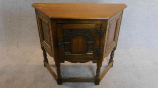 A small Jacobean style court cupboard fitted carved panel door. H.70 W.80 D.33cm