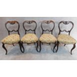 A set of four Victorian rosewood balloon back dining chairs H.84cm
