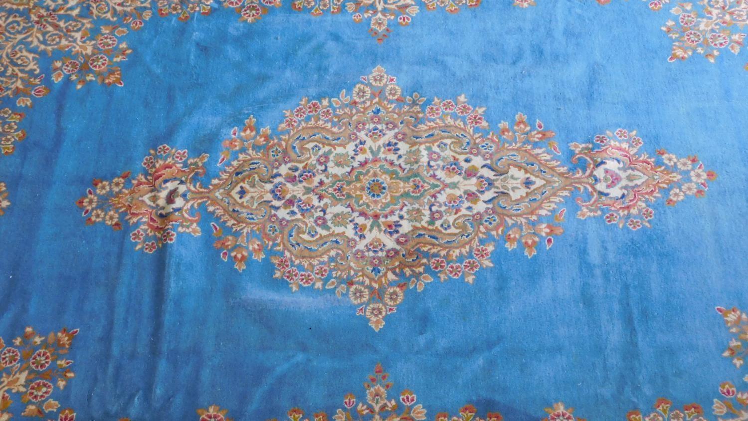 A Royal Kirman carpet with central double pendant medallion with repeating petal motifs on a sky - Image 2 of 4