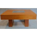 A low beechwood coffee table with inset glass top. 33x70x70cm
