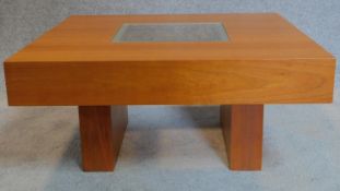 A low beechwood coffee table with inset glass top. 33x70x70cm