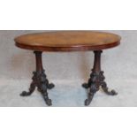 A 19th century burr walnut oval topped centre table on twin carved pedestal supports. H.73 W.112 D.