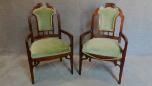 A pair of walnut framed Art Nouveau carved back armchairs. H.106cm