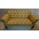 An Edawrdian sofa in original floral tapestry style upholstery on mahogany cabriole supports.