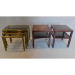 A nest of vintage brass framed tables with smoked glass tops and a pair of teak low tables.