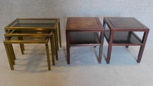 A nest of vintage brass framed tables with smoked glass tops and a pair of teak low tables.