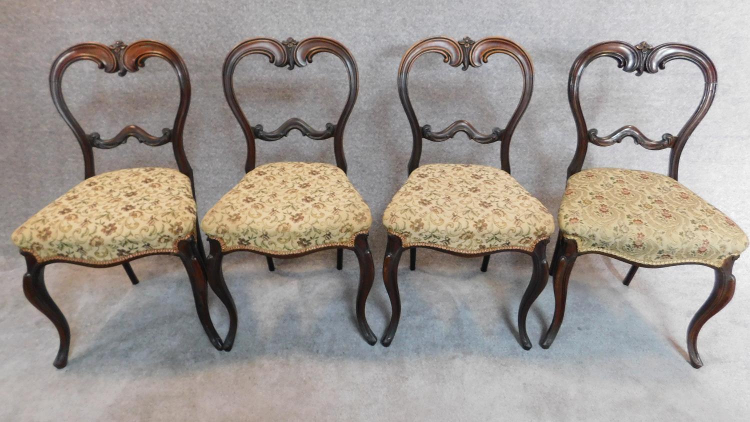 A set of four Victorian rosewood balloon back dining chairs H.84cm